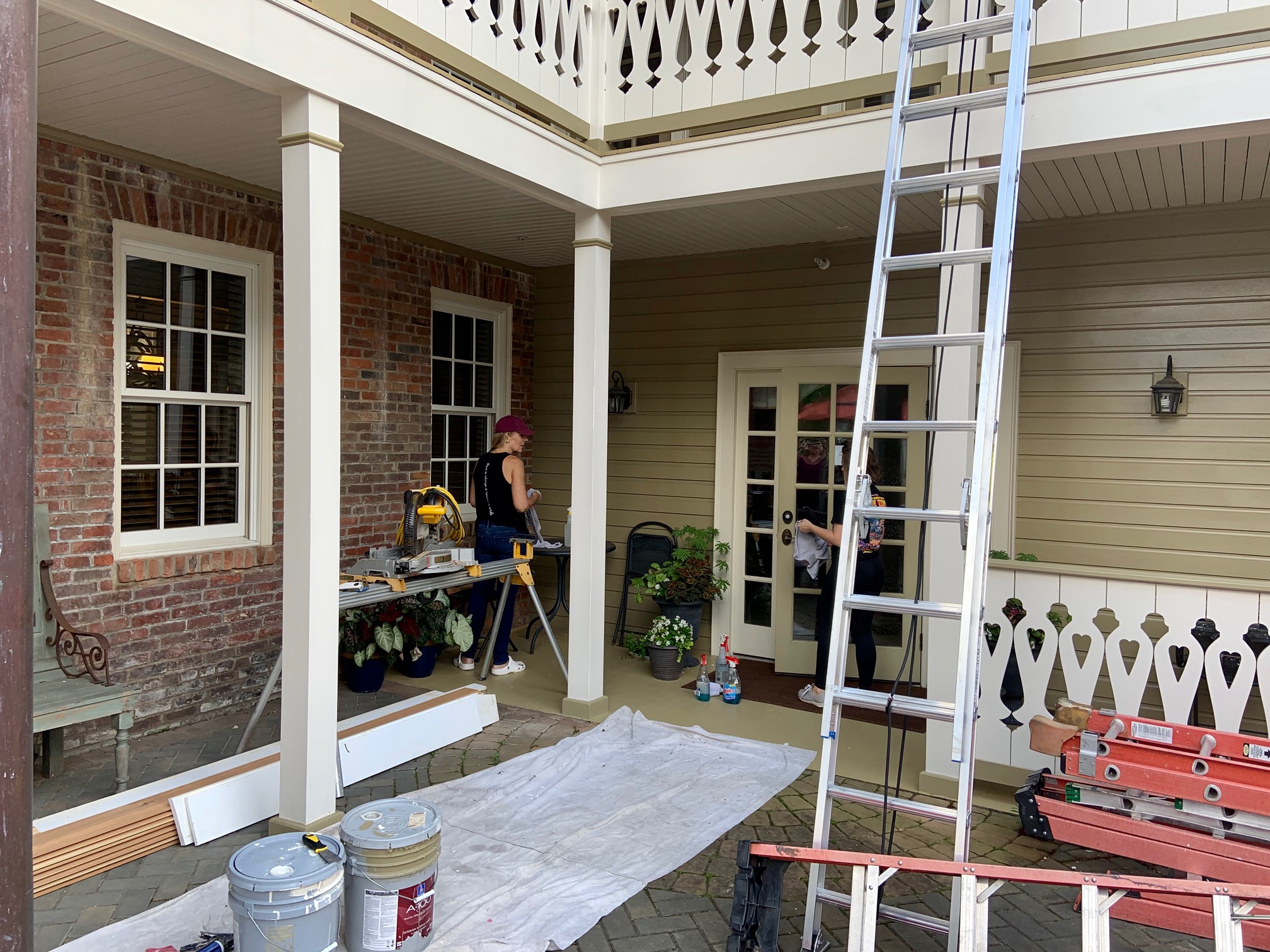 A house exterior with a covered porch under construction or renovation.